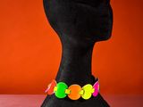 a black mannequin head with colorful buttons on it
