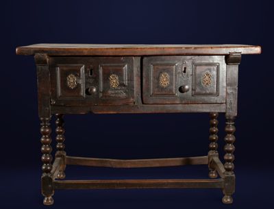 an old wooden table with two drawers on top of it