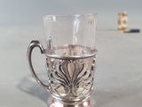 a small glass cup with a handle on a table