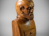 a wooden bust of a man with a beard and a hat