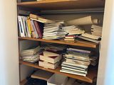 a closet filled with lots of books and papers
