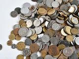 a pile of coins sitting on a white surface