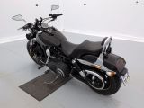 a black motorcycle that is parked in a room