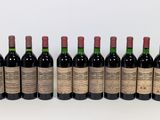 six bottles of red wine lined up in a row