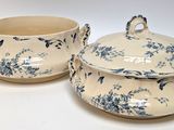 two blue and white bowls and a bowl on a white surface