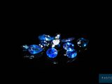 some very pretty blue and white crystals on a black surface