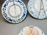 several pieces of blue and white plates with designs on them on a table