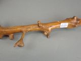 a wooden branch with a tag on it on a table