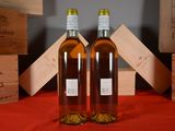 two bottles of wine sitting next to each other on a table