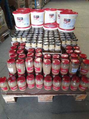 many jars of food sitting on a pallet in a warehouse