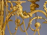 a golden candelab with a lion head on it