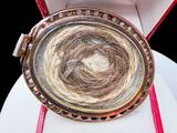a ring with a bird ' s nest inside of it