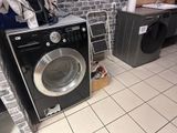a washer and dryer in a room with a brick wall