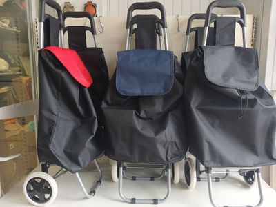 three shopping carts are lined up on a shelf in a store
