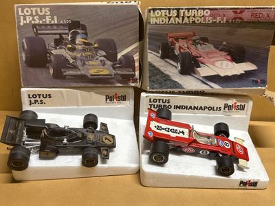 three boxed boxed toys of racing cars on display in a cardboard box