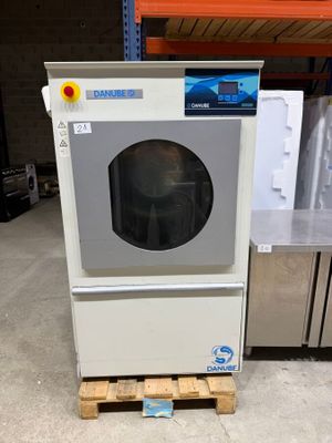 a washing machine sitting on a pallet in a warehouse