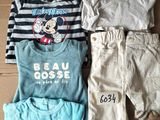 three children ' s clothing items laid out on a cardboard box