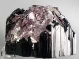 purple and white crystals on a clear glass stand against a white background