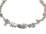 silver bracelet with animals and birds on it on a white background