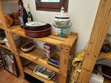 a wooden shelf with pots and pans on it in a kitchen