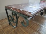 a table with a marble top sitting on a hard wood floor