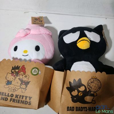 two stuffed animals sitting next to each other on a table