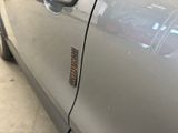 a close up of a car door handle with a sticker on it