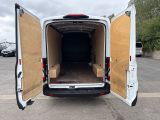 the back of a white van with its doors open in a parking lot