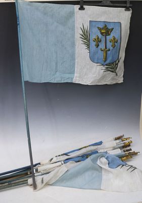 a small flag hanging on a wall next to a pair of arrows