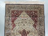 a close up of a rug on a white surface with a blue background