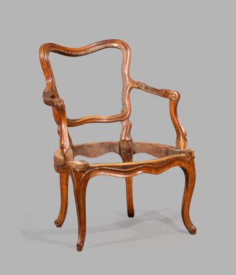 an image of a wooden chair with a carved back and arms