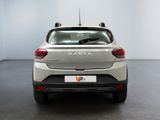 the rear end of a silver car in a white room