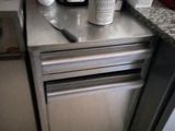 a small kitchen with a coffee maker and a dishwasher