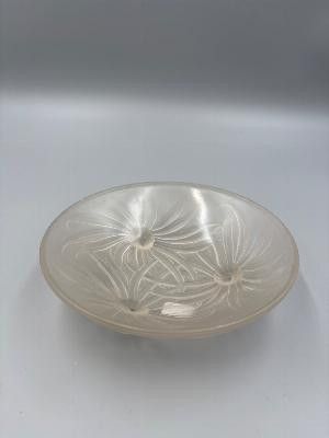 a glass bowl with a design on it on a table