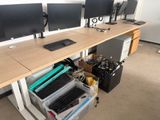 a desk with two computer monitors and a keyboard on it