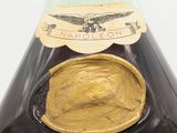 an image of a bottle of liquor with a gold label on it