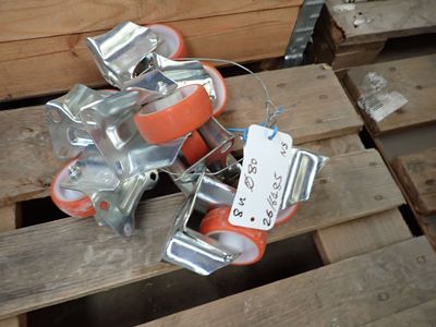 a pile of orange and silver rollers on a pallet