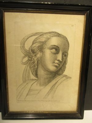 un vieux dessin représentant le visage d'une femme, dans un cadre noir