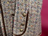 a close up of a jacket with a fur collar on a mannequin