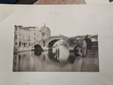 a black and white photo of a bridge over a river