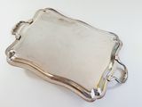 a silver tray with a handle and handles on a white surface