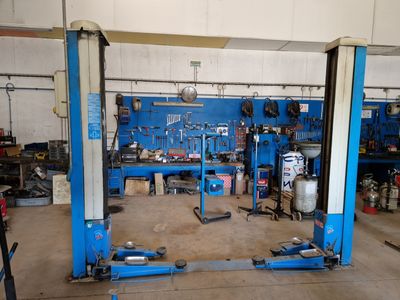 a picture of a garage with a lot of tools on the floor