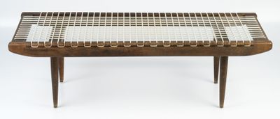 the table is made of wood and has a woven top