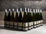 several bottles of wine are lined up in a row on a table