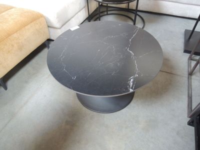 a black table with a marble top in a living room