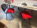 a table with chairs and a laptop on it in a room