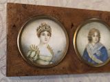 two framed pictures of a woman and a man on a wall
