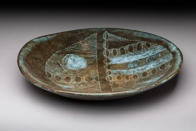a brown plate with a fish design on it