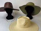 two hats on a mannequin head and a hat on a mannequin head