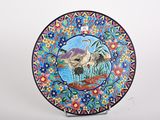 a decorative plate with a picture of two birds on it